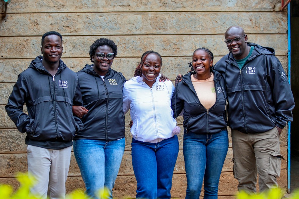 Spur Afrika team members in branded jackets